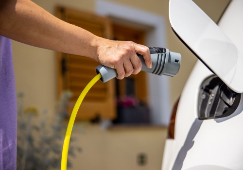  Person charging an electric vehicle at home 