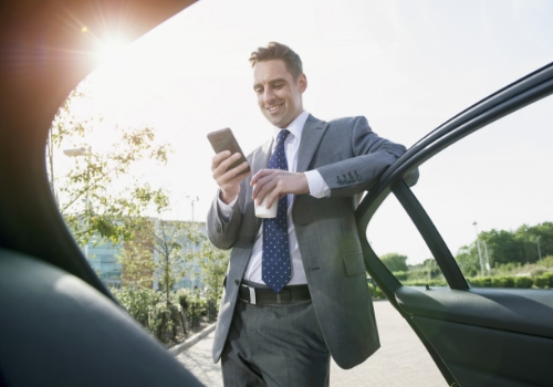 Man on cell phone with his rental car 