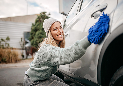 Woman washing her car in the street