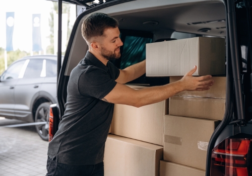  Man putting boxes in a commercial van